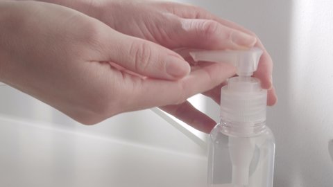 Close-up of woman using hand sanitizer gel to prevent spreading virus (such as corona virus  covid-19  sars-cov-2) or bacteria. 4k real time footage.   