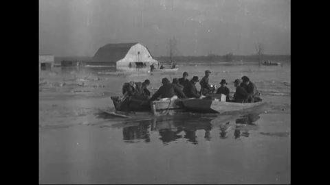 CIRCA 1930s - A historic flood on the Mississippi River results in rescuers and victims traveling in motor boats through flooded towns.