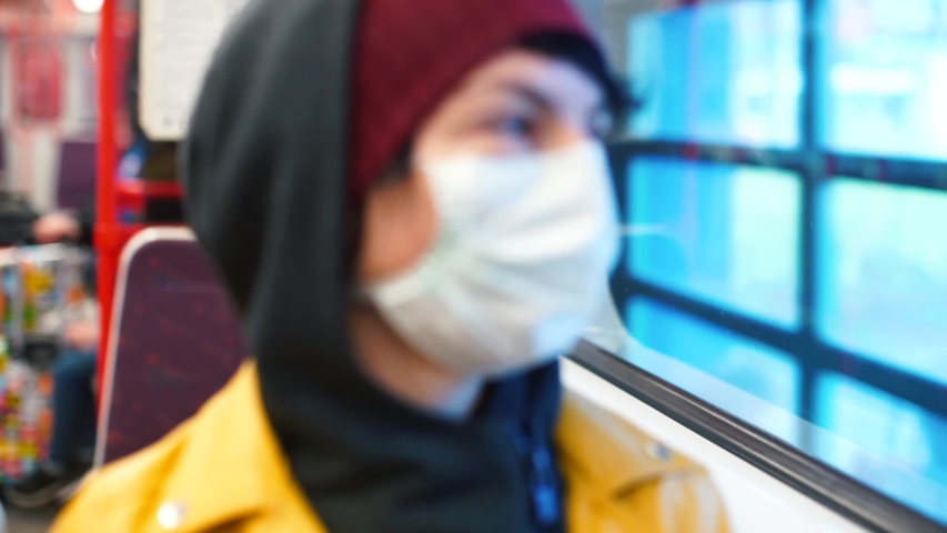 Evacuation of tourists Woman in medical mask in train. Masked woman rides subway quarantine zone, grim reality of pandemic life city evacuations to curb contagion evacuation of people. Sick viral face Royalty-Free Stock Footage #1048423273