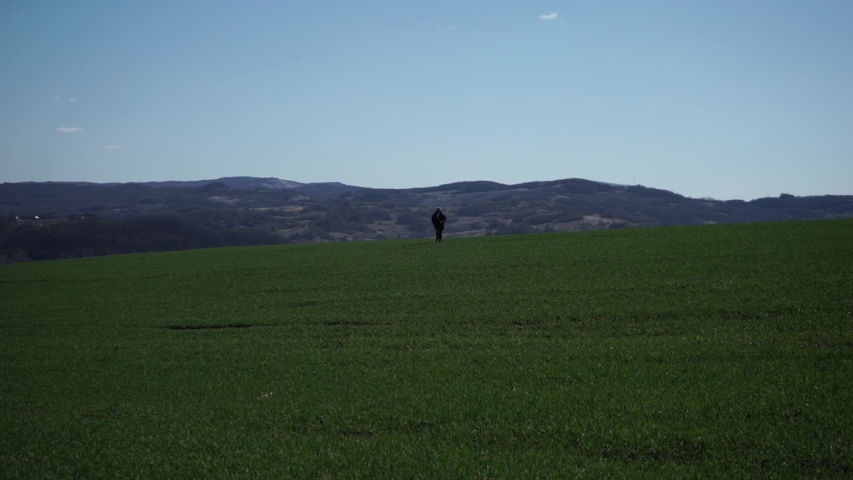 Young guy running across the field
