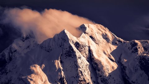 Cinemagraph Continuous Loop Animation. Dramatic Aerial View of Snow and Cloud Covered Canadian Rocky Mountains during winter day. Remote Area Northwest of Vancouver, British Columbia, Canada.