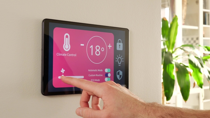 Controlling the temperature of the home using a smart house control panel screen. | Shutterstock HD Video #1048441915