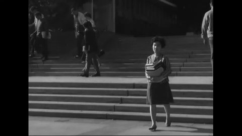 CIRCA 1966 - Coed students traverse UCLA campus.