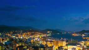 Nagasaki, Japan. A sunrise timelapse made from a hill in Nagasaki, Japan, with a view over the entire center, including the bay and the hills, panning video