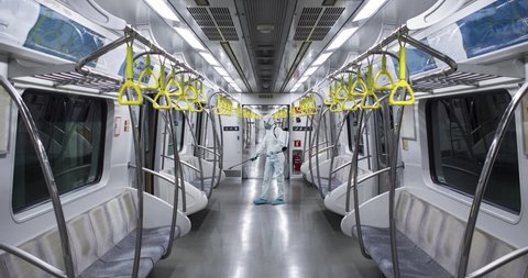 HazMat team in protective suits decontaminating metro car during virus outbreak. 50 FPS Slow motion