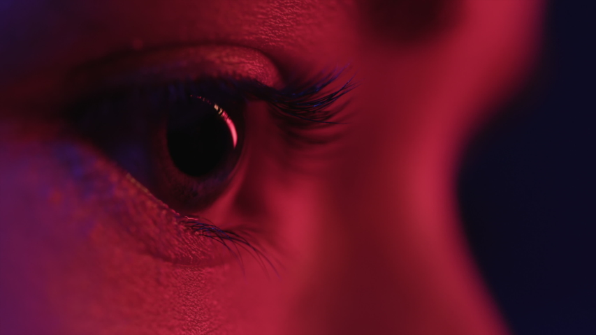 Pretty Eyes of Woman in Colourful Neon. Girl Looking Around at Studio. Abstract Shot of Female Face and Skin with Multi-Colour Flickering of Modern Street Signs. Concept of Young Lady in Red Lighting Royalty-Free Stock Footage #1048476538