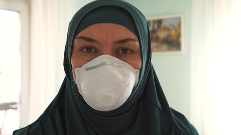 Coronavirus COVID-19 pandemic. Muslim woman in protective medical mask. Muslim Americans Black Lives Matter