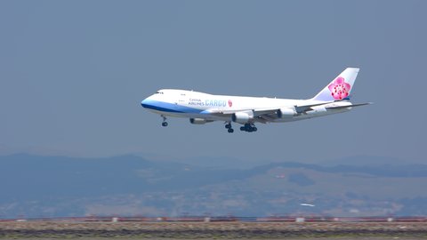 SAN FRANCISCO, CA - 2020: Air China Cargo Boeing 747-400 Freighter Jet Airplane Landing on Runway Arriving into San Francisco SFO International Airport Flying Over the Bay Area on a Sunny Day