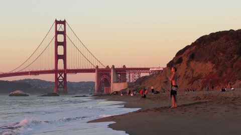 Unidentified people at Baker Beach in San Francisco, California, the Golden Gate bridge in the background, 2018