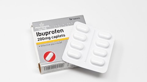 London / UK - March 17th 2020 - Packet of Ibuprofen anti-inflammatory painkillers, closeup with blister pack of tablets slowly rotating on a white background
