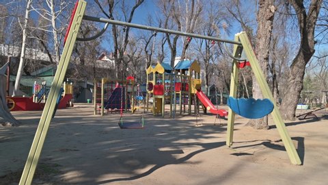 Chisinau, Moldova - March 17, 2020: Empty children playground in cathedral square park in the center of city during quarantine by reason of coronavirus AKA covid-19 virus threat. State of emergency