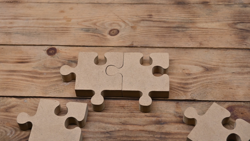 Wood Puzzle for teamwork achievement. Playing jigsaw game. Business successful and goal concept Royalty-Free Stock Footage #1048525189