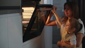 The family cooks together. Mother and daughter put the pie in the oven and close the door. Watch and wait for homemade pizza cooking. Happy childhood, help your mother. - Powered by Shutterstock - Get 15% off with code: PIKWIZARD15