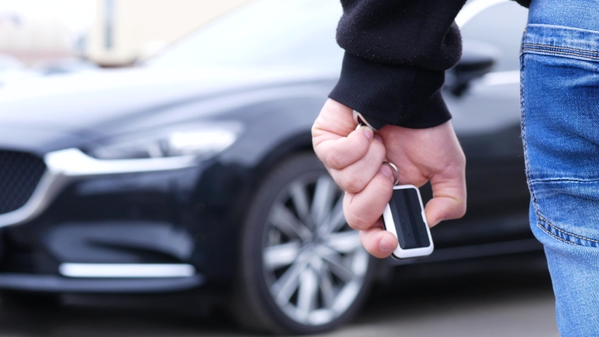 the owner of the car opens the door with an alarm using a key fob on the key - Powered by Shutterstock - Get 15% off with code: PIKWIZARD15