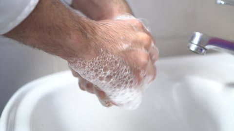 Person Rinsing Hands in Bathroom at Home. Washing Hands the way Coronavirus Rinse Water Rub Soap Dry Towel Covid.