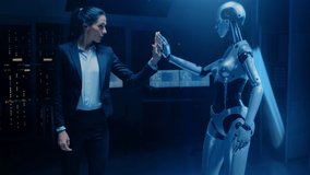 Beautiful Successful Business Woman Wearing Suit Touching Hands with Humanoid Robot Activating Collaboration, Teamwork Protocol. People and Artificial Intelligence Working Together - Powered by Shutterstock - Get 15% off with code: PIKWIZARD15