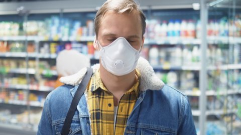 portrait. man in medical mask at the grocery store. pandemic.