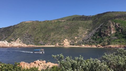 Loaded tourboat returns from Knysna Heads in Garden Route, S Africa