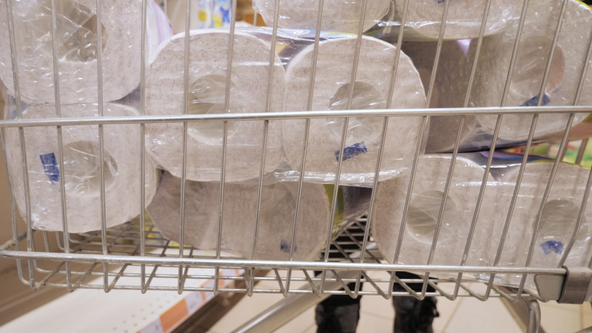 Coronavirus quarantine shopping. Preparing and stock up for coronavirus quarantined at home during the coronavirus pandemic. Panic. Deficit. Buying toilet paper. Local residents shop at a supermarket. | Shutterstock HD Video #1048571128