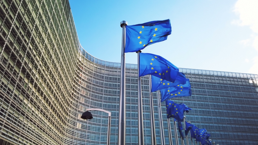 European Union flags waving in wind in front of European Commission building. 4K, Ultra High Definition, Ultra HD, UHD, 2160P, 3840 x 2160 Royalty-Free Stock Footage #1048573900