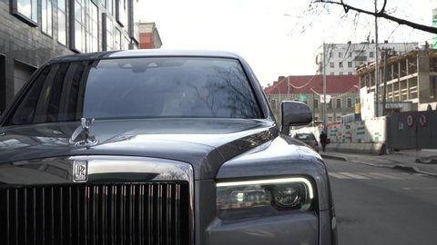 Moscow, Russia - 13 03 2020: Chasing a car on a Rolls Royce Cullinan. An expensive exclusive car draws the car in front, signals and blinks headlights.