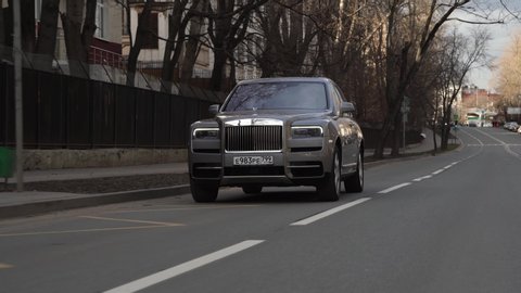 Moscow, Russia - 13 03 2020: Great footage of expensive Rolls Royce Cullinan who rides on the road and blinks turn signals