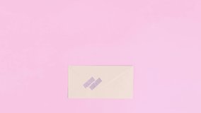 Stop motion animation opening envelope and growing flowers on pink background. Creative flat lay love spring wedding  concept