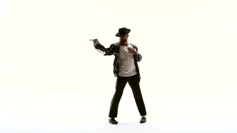 Young stylish teenager is showing dance moves like Michael Jackson. Isolated over white background. Close up, slow motion.