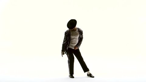 Young stylish teenager is showing dance moves like Michael Jackson. Isolated over white background. Close up, slow motion.