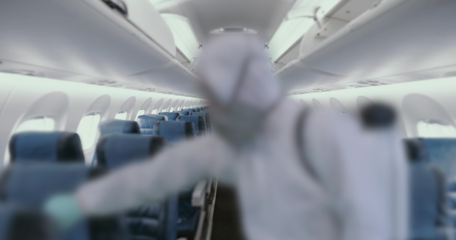 HazMat team in protective suits decontaminating airplane cabin during virus outbreak. Coronavirus, COVID-19 Royalty-Free Stock Footage #1048599304