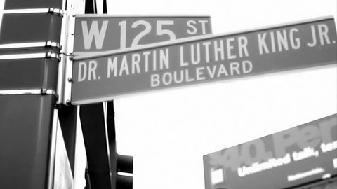 NEW YORK - FEB 9, 2010: vintage style black and white 16mm film footage of 125 and Martin Luther King Blvd sign in Harlem NY. Harlem is a famous neighborhood in Uptown Manhattan, NYC, USA.