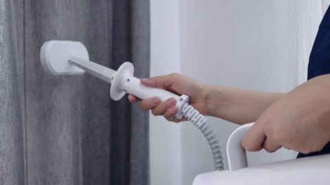 Slow motion Close up shot Asian woman cleaning curtain with steam vapor cleaner, Housewife cleaning house for good family healthcare