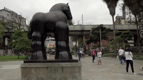 Unidentified people at the Botero Plaza (Botero Square) in downtown Medellin, Colombia, circa April 2019