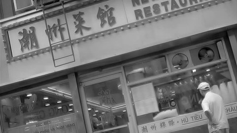 NEW YORK - FEB 9, 2010: driving by Chinese restaurants, stores in black and white vintage archival style footage in Chinatown, NY. Chinatown is a famous neighborhood in Downtown Manhattan, NYC, USA.