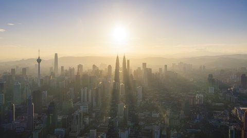 Cityscape Time lapse : Aerial Kuala Lumpur city view during morning overlooking the city skyline with beautiful ray of lights in Malaysia.