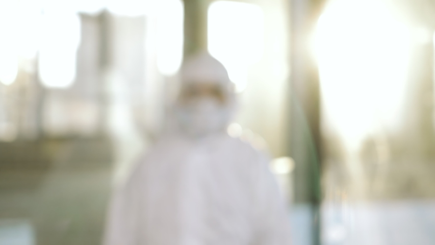 Portrait of epidemiologist protecting patients from coronavirus COVID-19 in mask. Global pandemic epidemic, Europe, Italy, USA. Doctor virologist working in suit, glasses. Appearance from blur Royalty-Free Stock Footage #1048609798