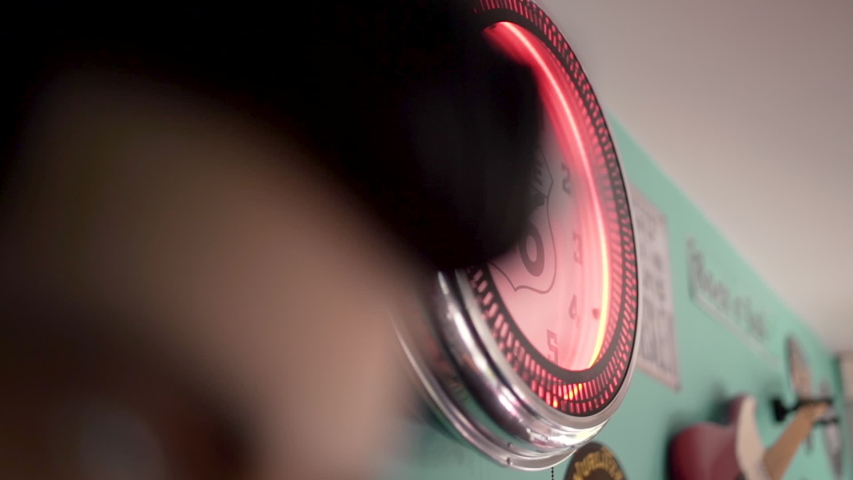 An old red vintage retro clock with route 66 hanging on the wall.