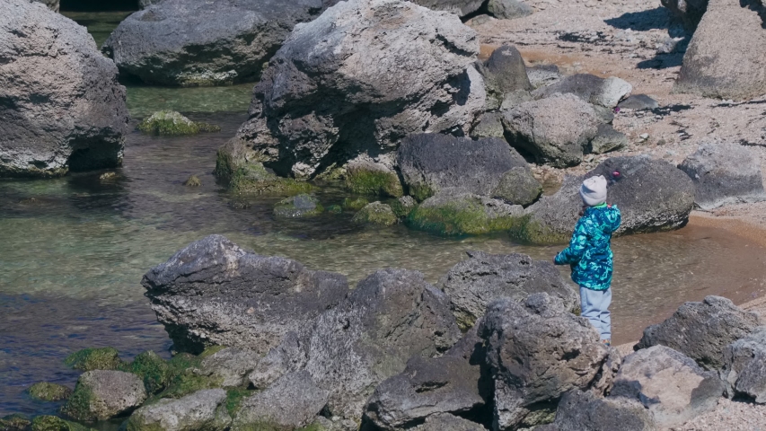 Kid fishing among the rocks