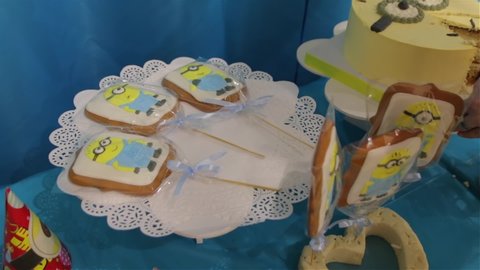 Kyiv, Ukraine - 10 02 2019: Sweets on children birthday cookies cake gingerbread minions on children happy birthday party yellow blue color candy bar