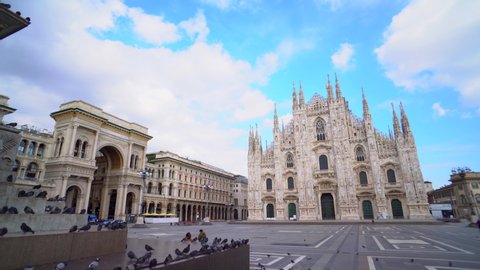Milan, Italy - March 19, 2020: Pigeons are waiting for people on an empty square in front of the cathedral. Chinese Covid Crown Virus 19. Quarantine. Pandemic. City of the desert. Piazza Duomo