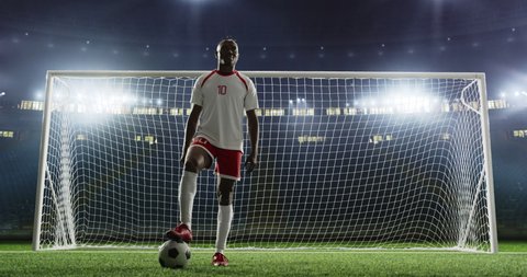 Soccer player is standing in front of the goal on the empty soccer stadium. No spectators on the tribunes. Stadium is made in 3D.