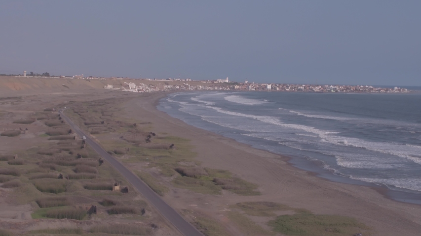 Static aerial drone view move of a Totota fiel near to Huanchaco Beach in Trujillo city at a sunny day in La Libertad Region, Peru