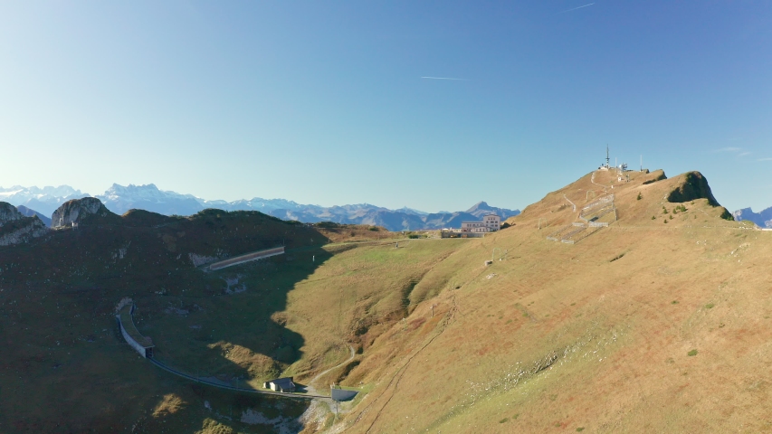 Aerial shot on Rochers-de-Naye Mountains ridge in Switzerland. Unique swiss railway that goes uphill. Clear footpath