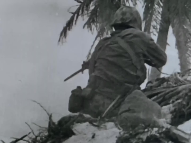 CIRCA 1943 - Marines use machine guns, hand grenades, and flamethrowers to attack Japanese soldiers in the Battle of Tarawa during WWII.