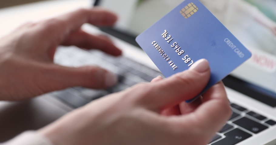 Female hands of cardholder holding credit card making e bank online payment. Woman consumer paying for purchase in web store using laptop technology. Ecommerce website payments concept. Close up view | Shutterstock HD Video #1048645585