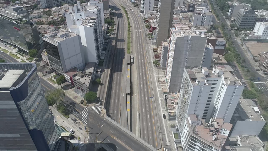 Miraflores district, in Lima Peru. During the lockdown for coronavirus. Empty streets, few public transportation. Aerial view. Some cars and buses in one of the more transit avenues in Lima. Royalty-Free Stock Footage #1048646965