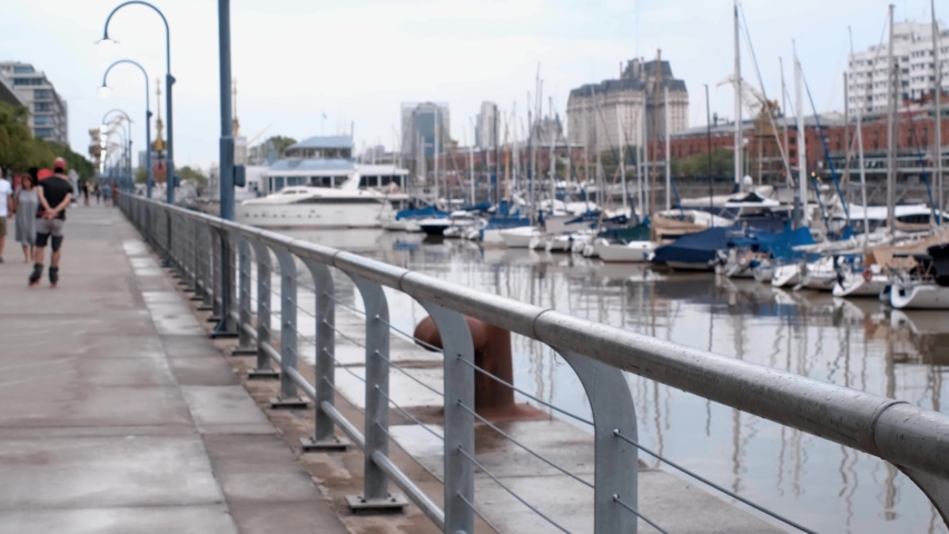 A girl walking along the lake with her dog