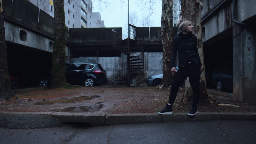 An alternative girl having fun walking like an anime character on a sidewalk