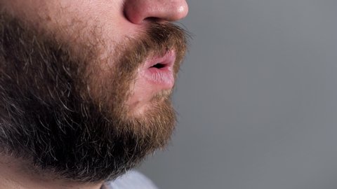 Man coughs and covers her mouth with napkin. Colds, flu, laryngitis, tuberculosis, asthma, bronchitis, allergies, pneumonia, APF inhibitors, nasopharyngeal leakage concepts. Side view. Close-up