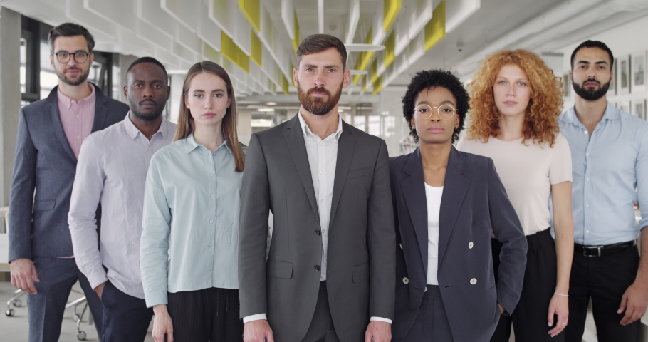 Proffesional multi ethnic team looking to camera.